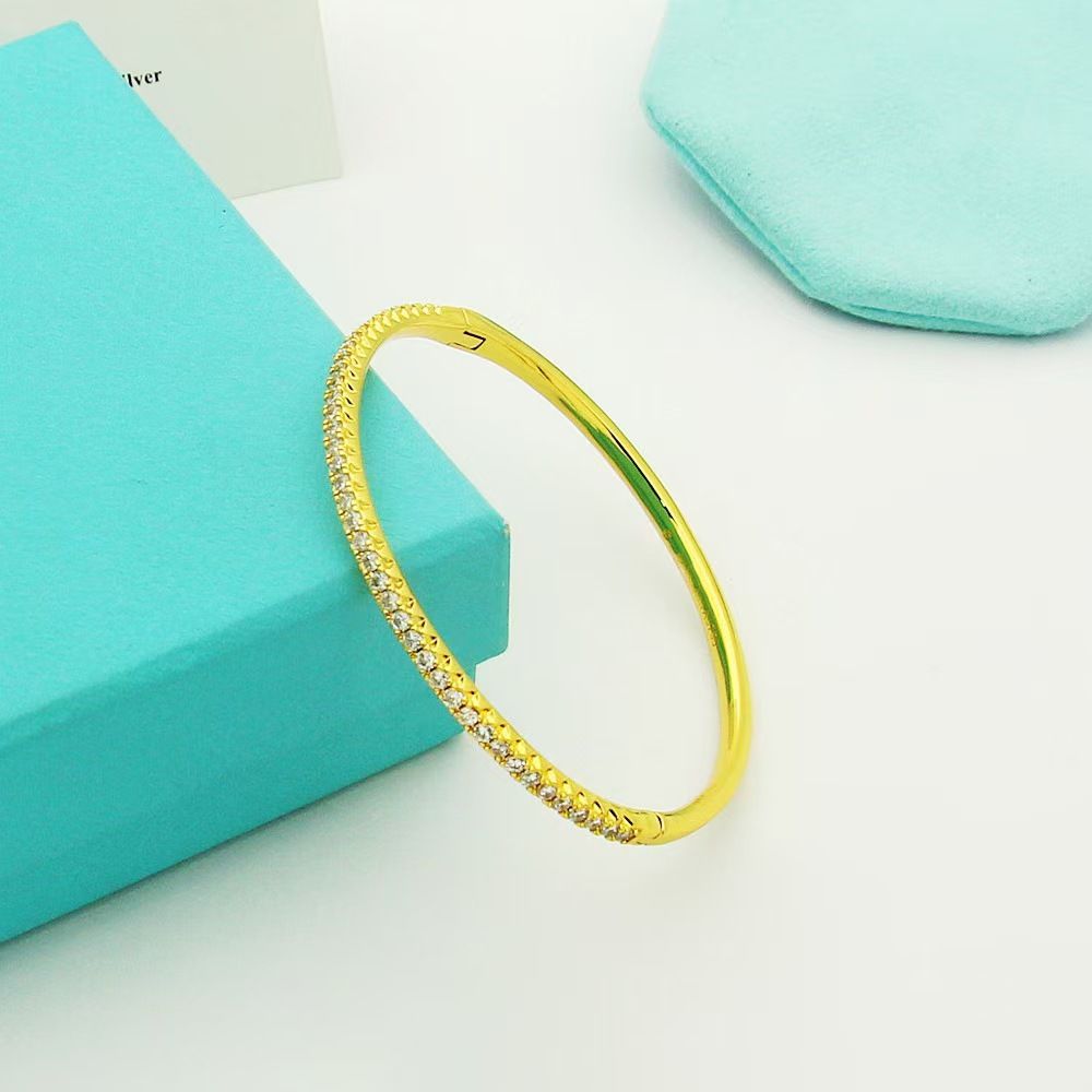 Gold-plated semi-circle bracelet with single row crystals