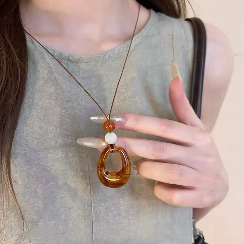 Round ring pendant necklace, black cord, long chain style