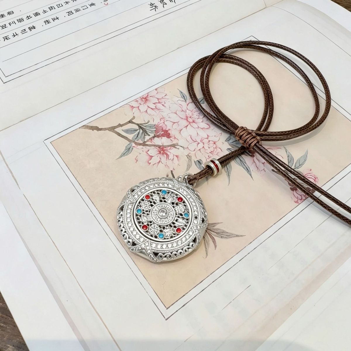 Silver rotatable Eight Treasures compass pendant, long sweater chain