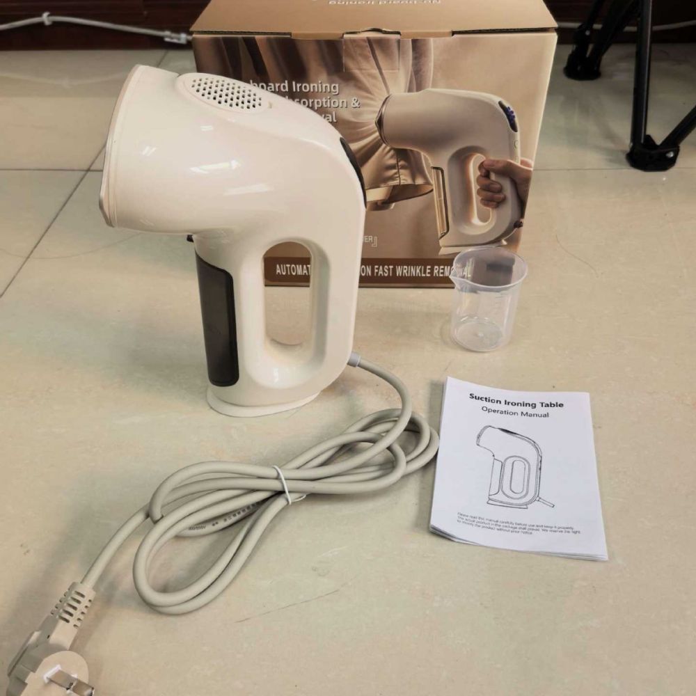 Handheld garment steamer with suction function
