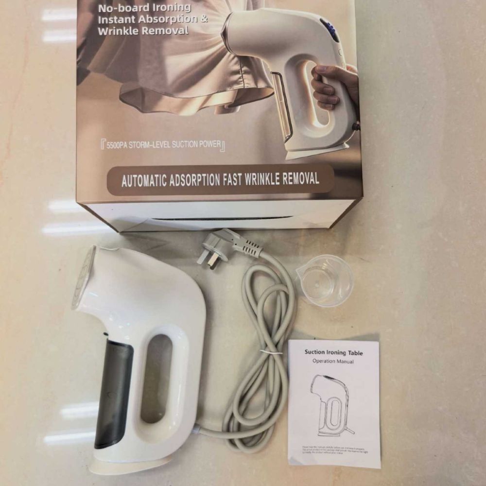 Handheld garment steamer with suction function