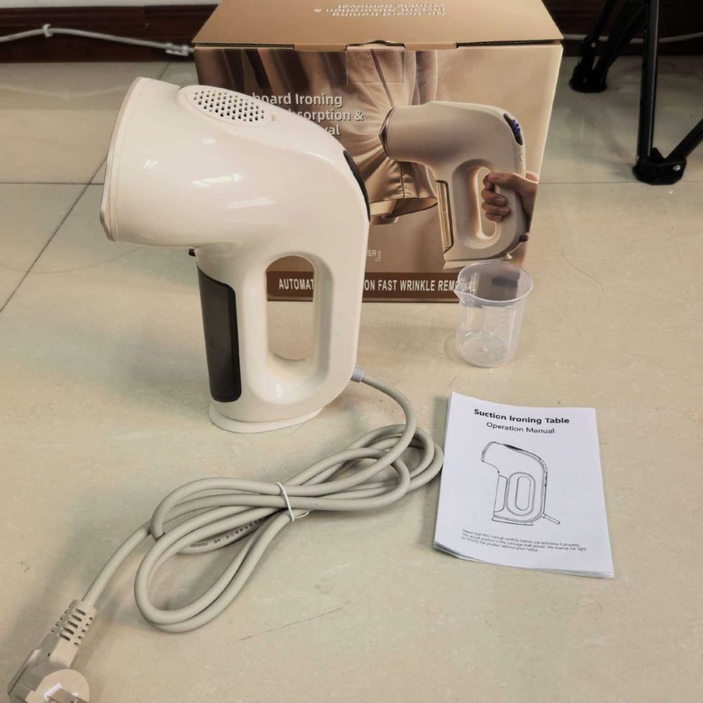 Handheld garment steamer with suction function