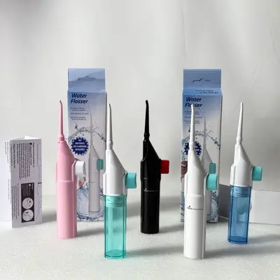 Portable manual water flosser oral irrigator