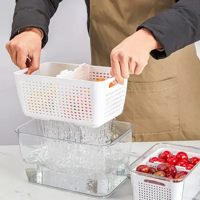 Kitchen refrigerator storage container with dividers and drain
